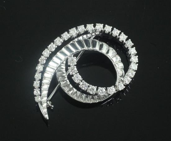 A modern 14ct white and diamond set scroll brooch, 41mm.